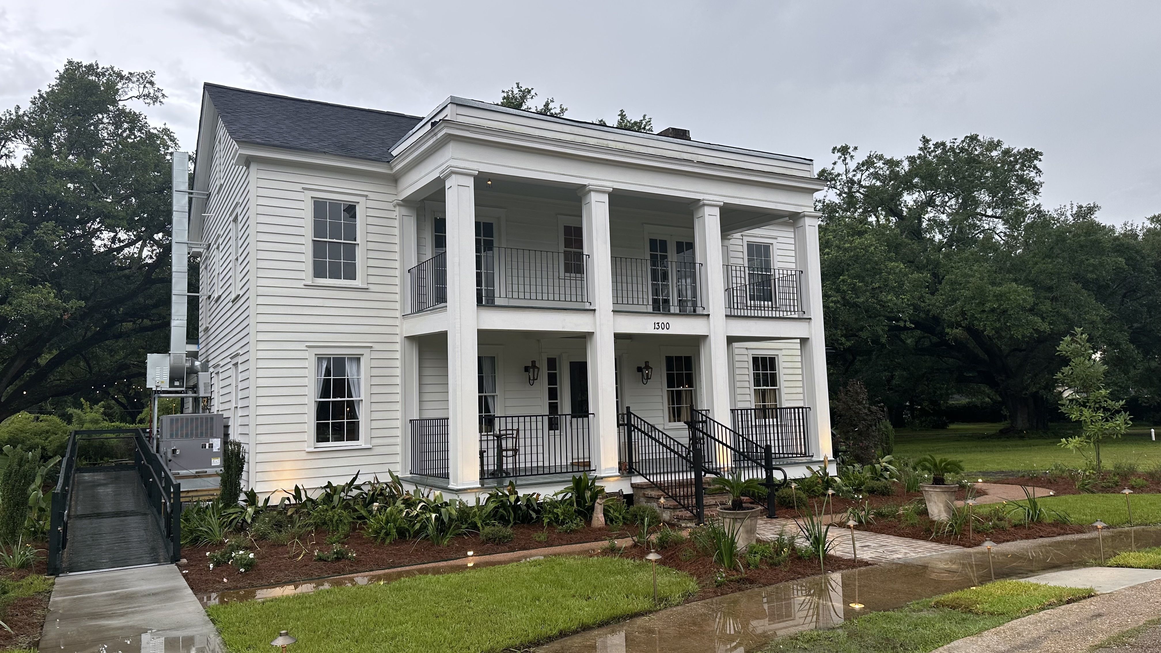 A large white house with four columns out front.