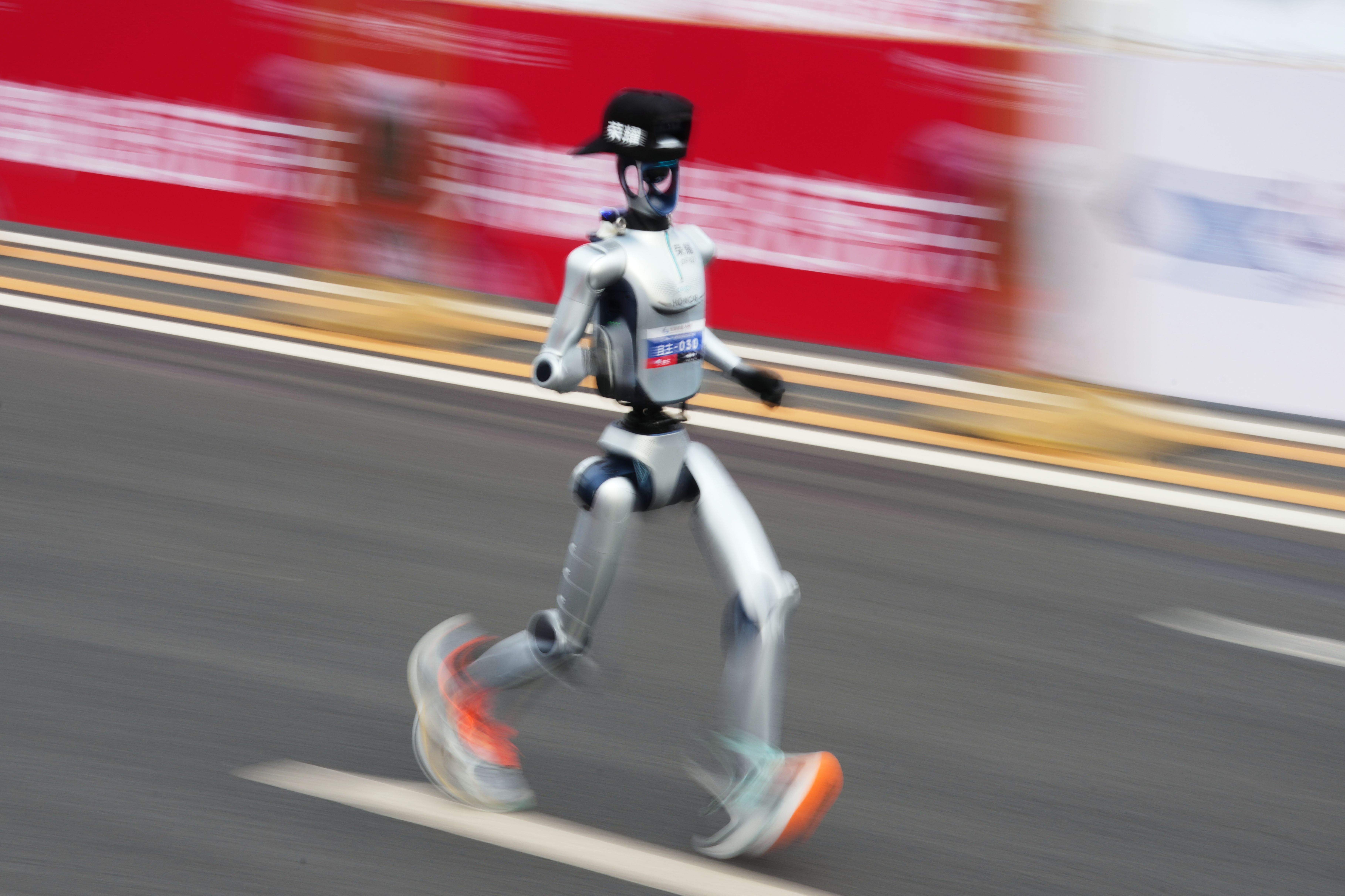 A robot starts off for the Beijing E-Town Half Marathon and Humanoid Half Marathon on the outskirts of Beijing on Sunday, April 19, 2026. (AP Photo/Ng Han Guan)