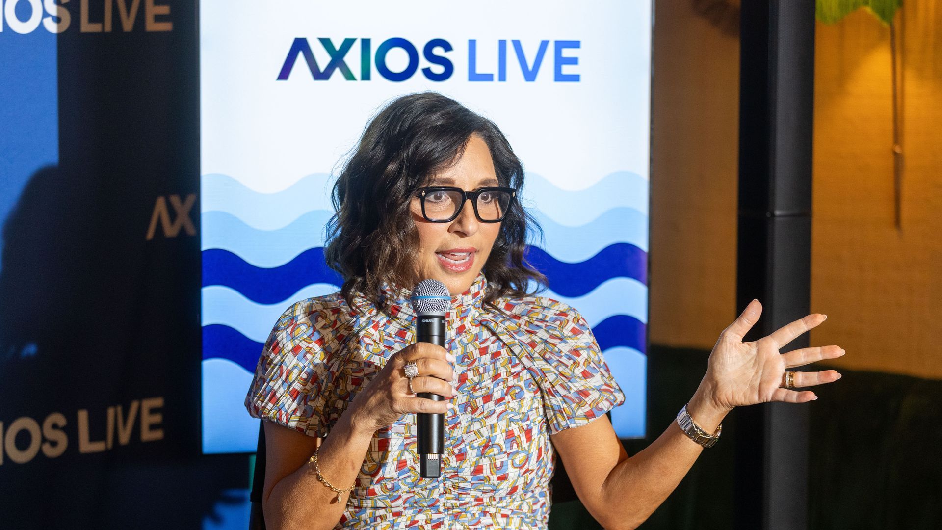 X CEO Linda Yaccarino addresses a crowd onstage at an Axios event in Cannes, France. 