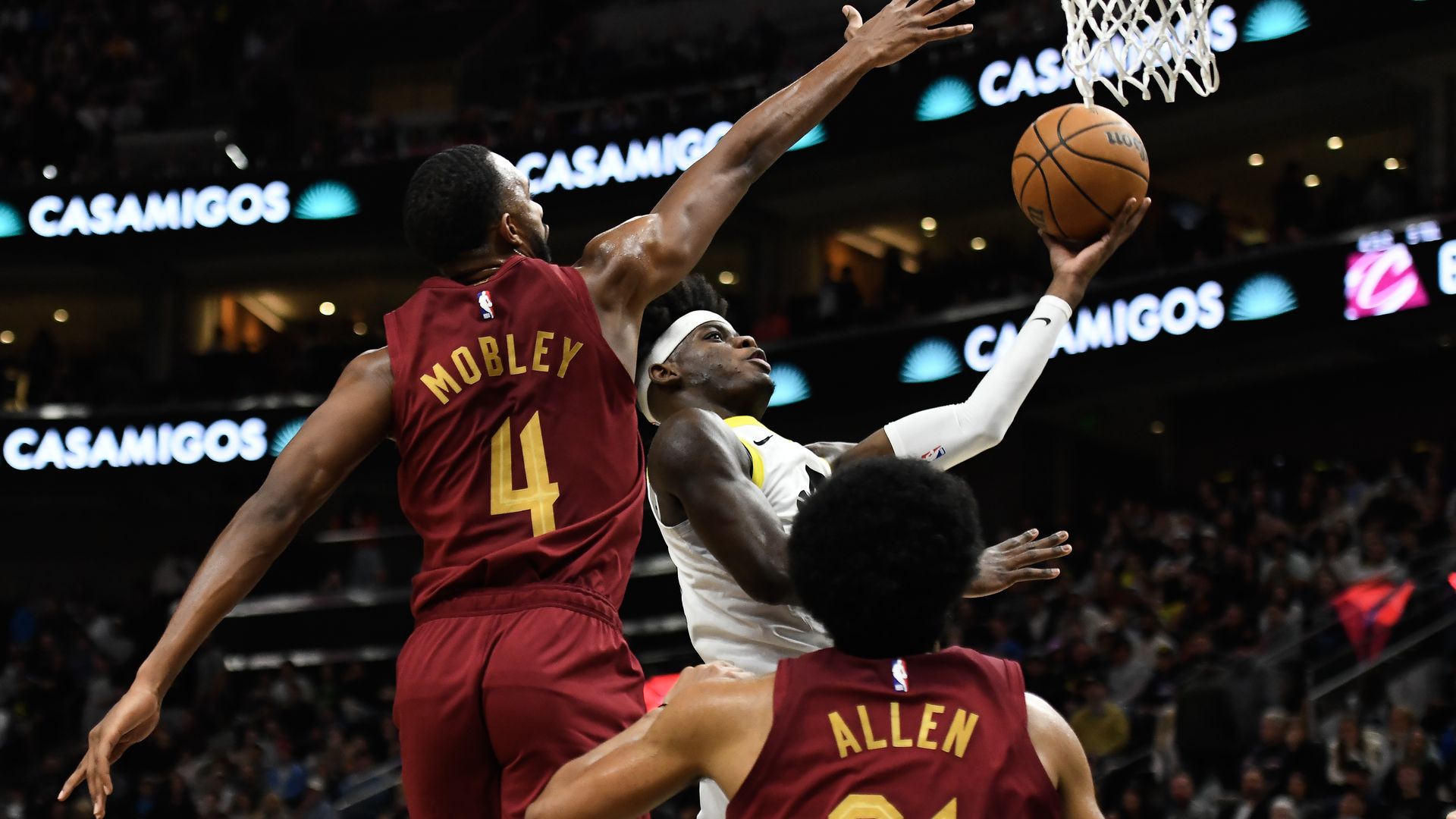 An image of the Cavs' Evan Mobley and Jarrett Allen, playing defense in red jerseys.