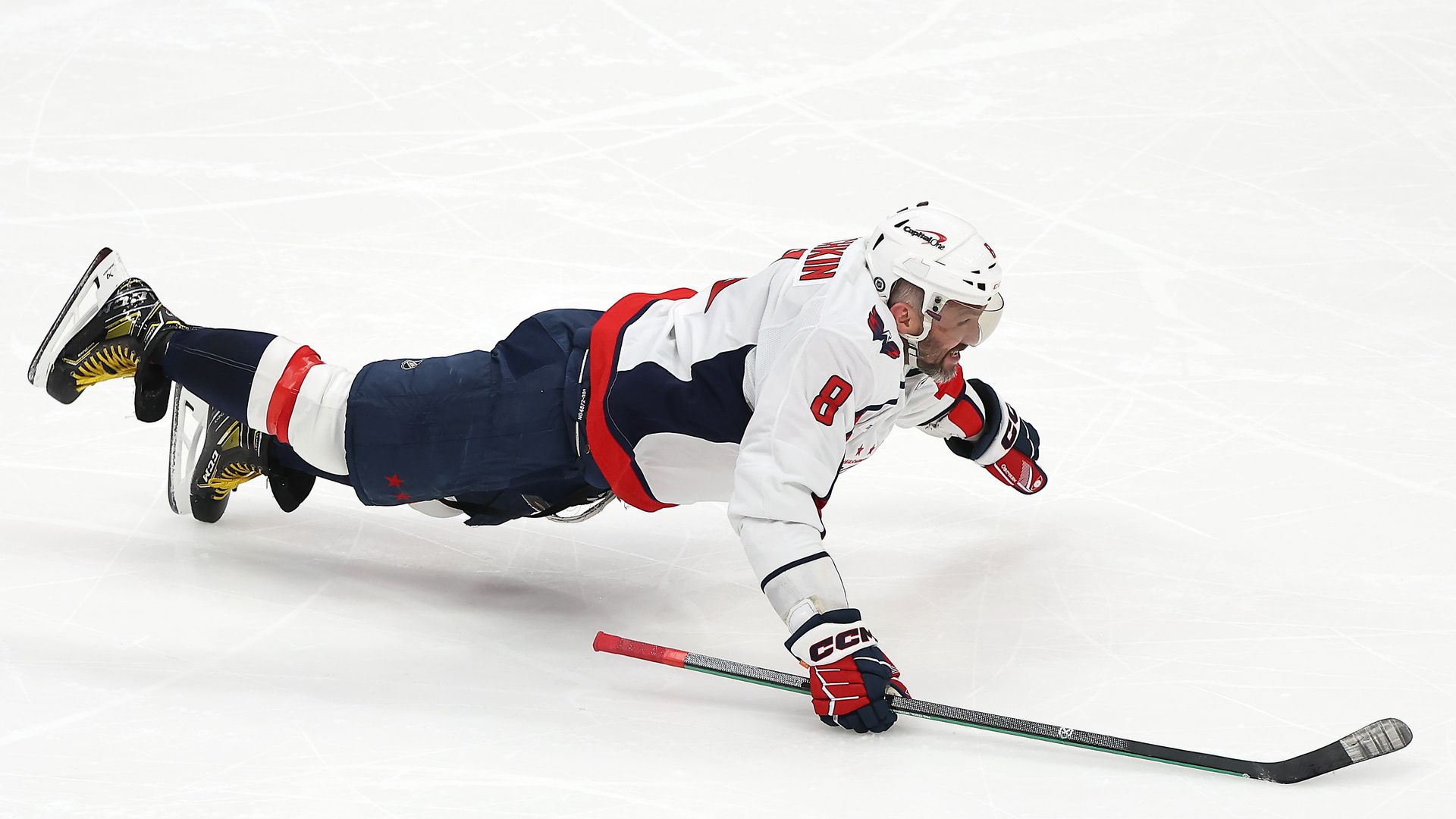 Alex Ovechkin celebrates after scoring record-breaking goal by laying out on ice