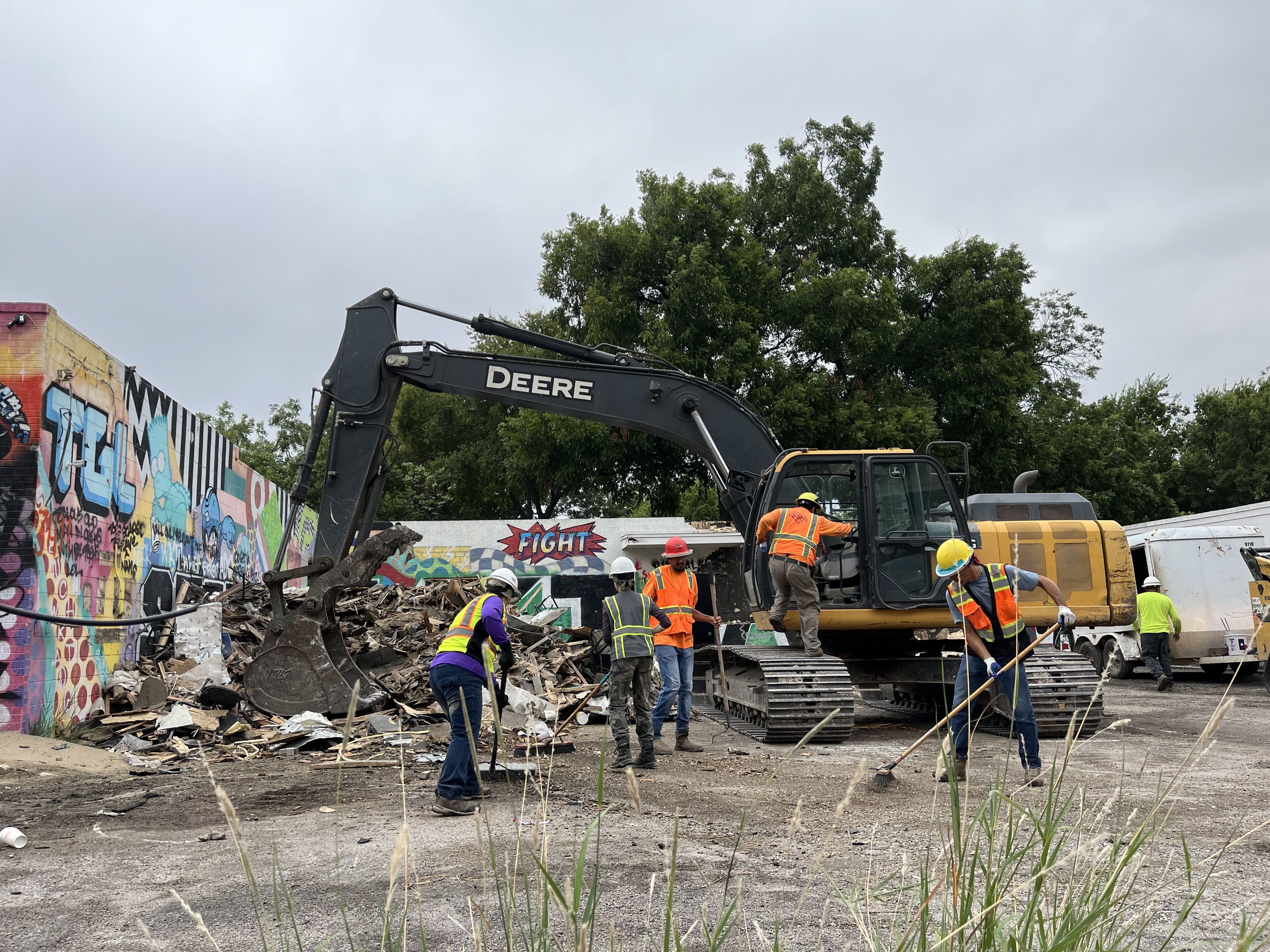 A construction crew gets rid of material.
