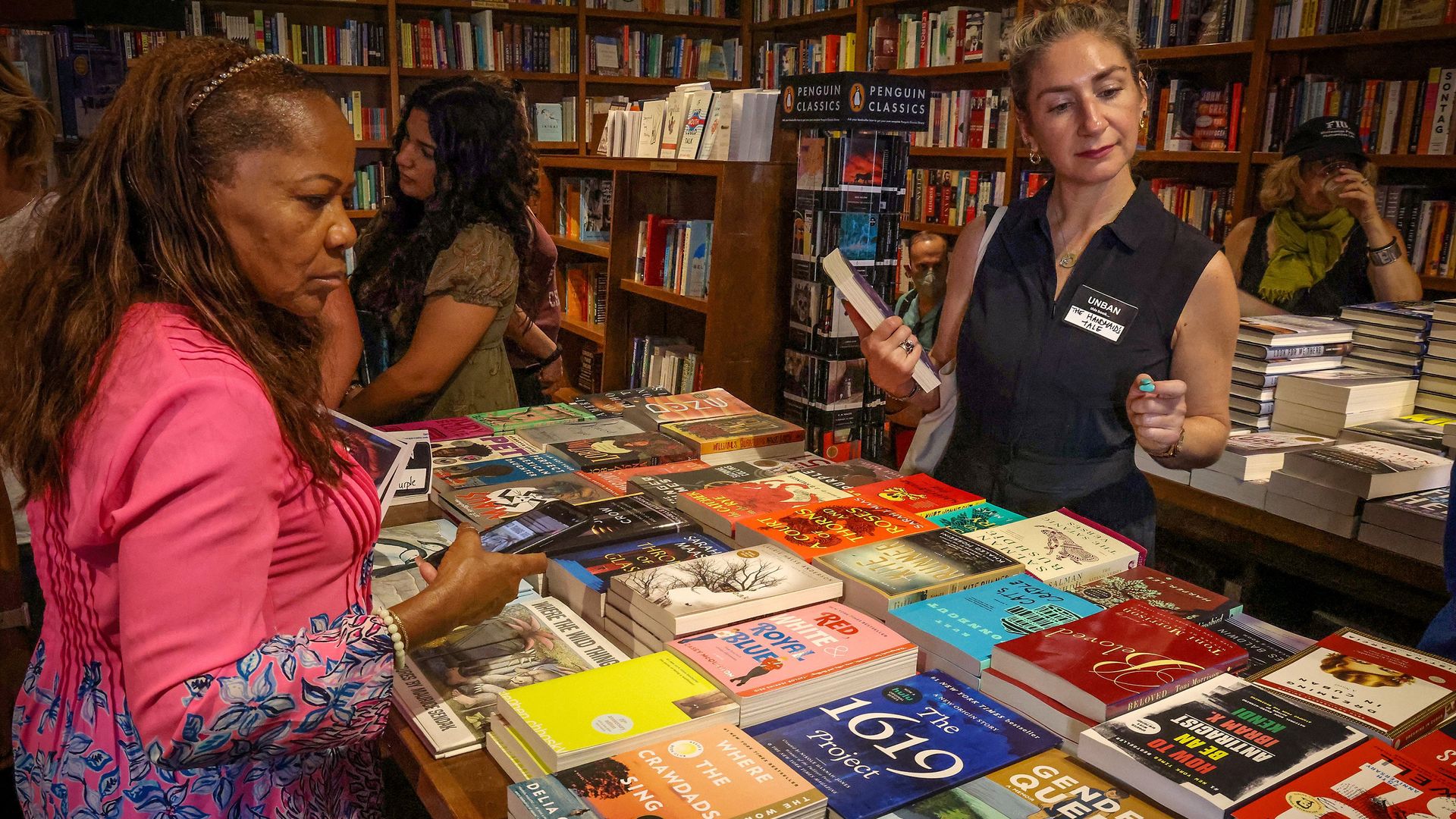 Educator Nancy St. Leger, left, and author Rebekah Shoaf, right, check some of the banned books displayed during the "Freadom" kickoff event at Books and Books in on Sunday, Oct. 1, 2023 in Coral Gables, Florida. 