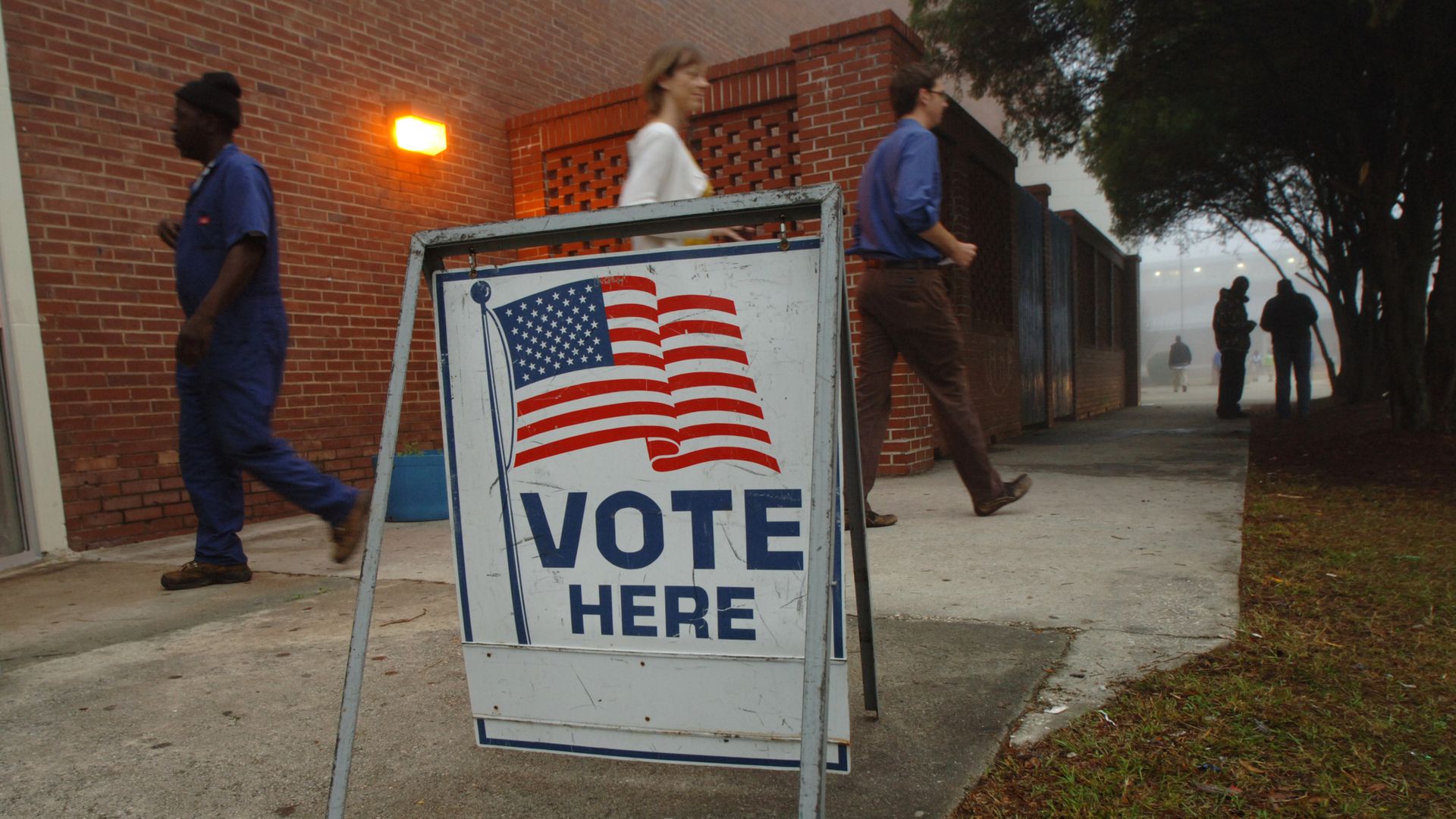 Voters leave a precinct after casting their ballots. 