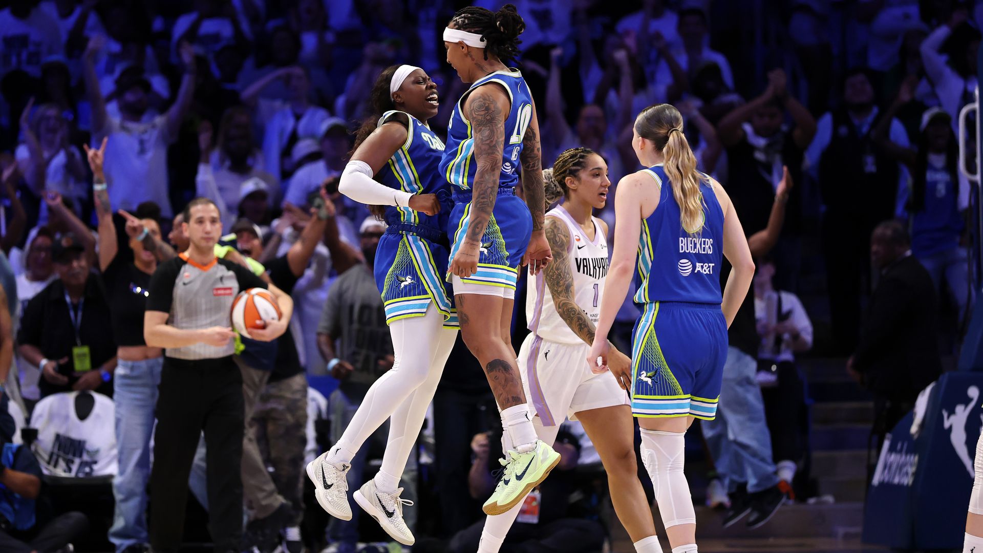 Arike Ogunbowale #24, Aziaha James #10, and Paige Bueckers #5 of the Dallas Wings celebrate.