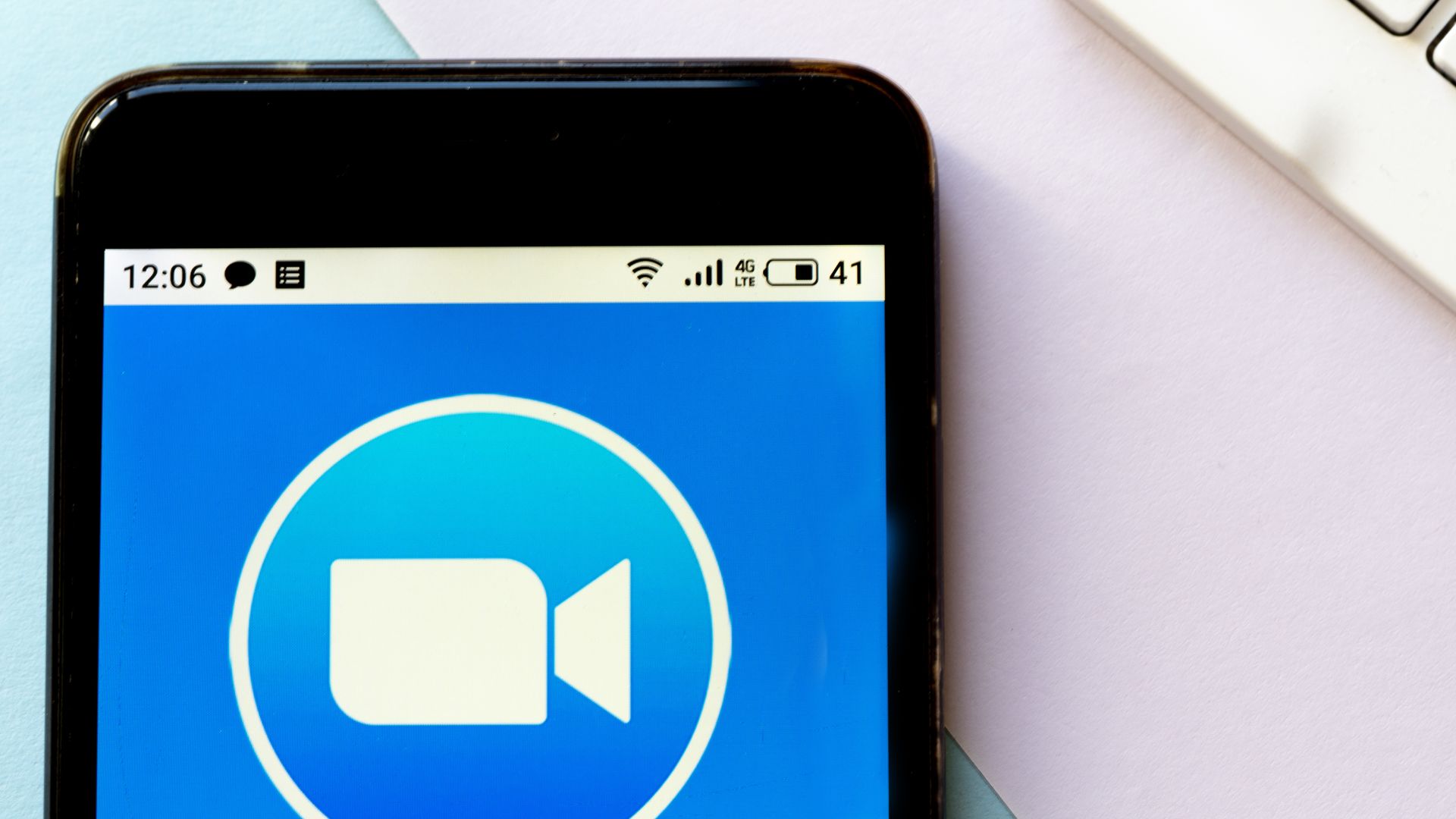 In this image, the Zoom logo is displayed on a phone