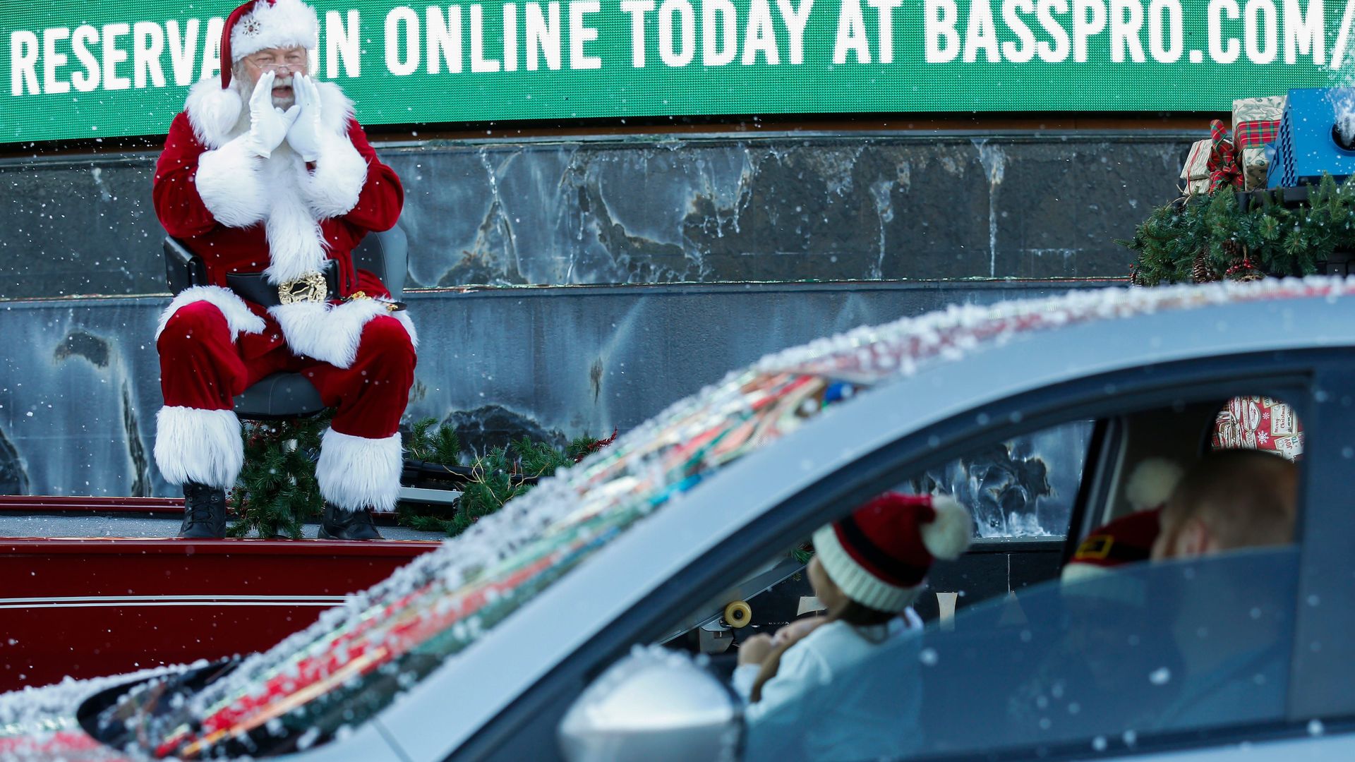 Santa shouts to a family at a Bass Pro Shops drive-by Christmas kickoff last Saturday in Springfield, Missouri.