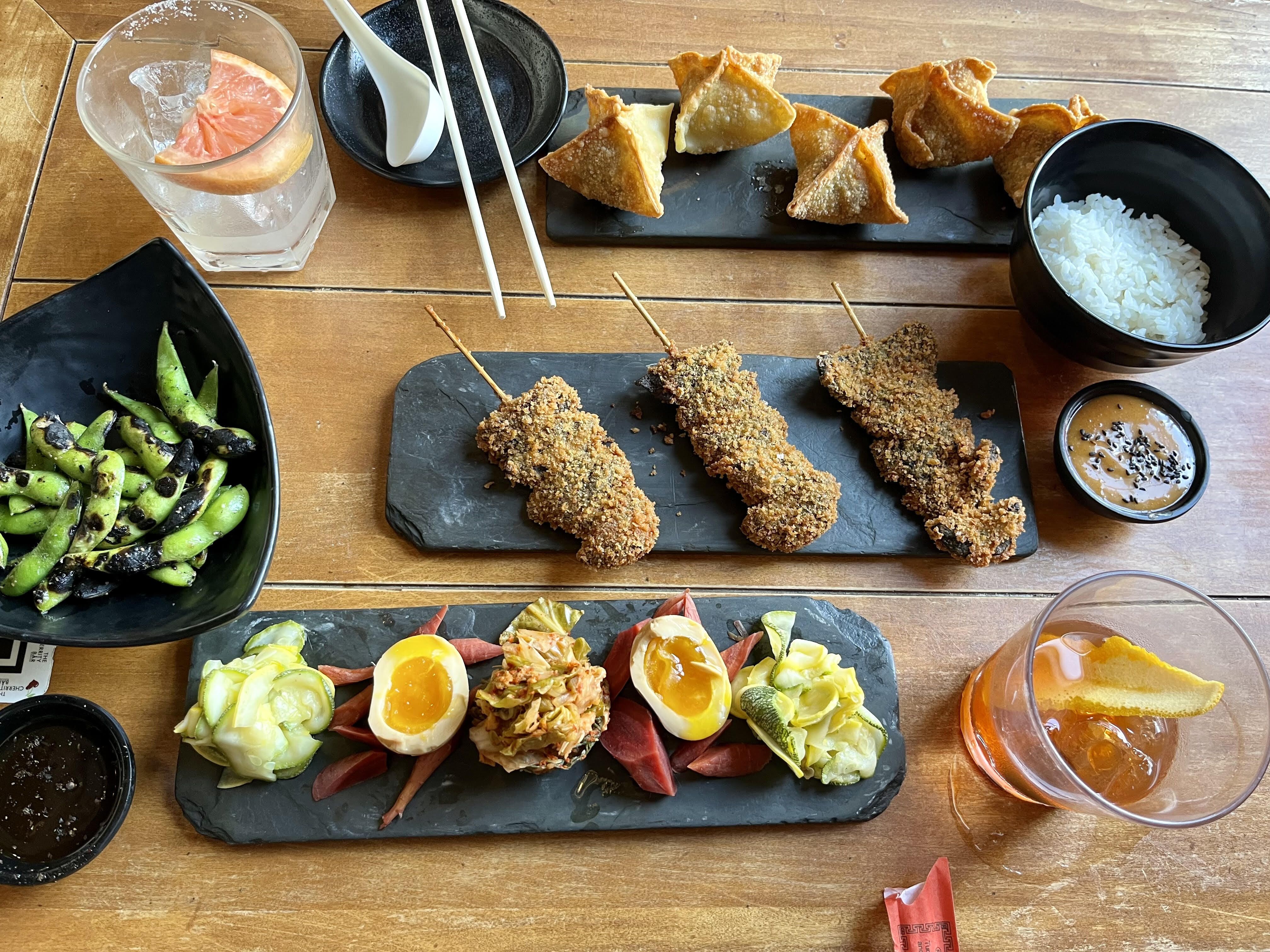 An overhead view of a spread made up of various appetizers and drinks.