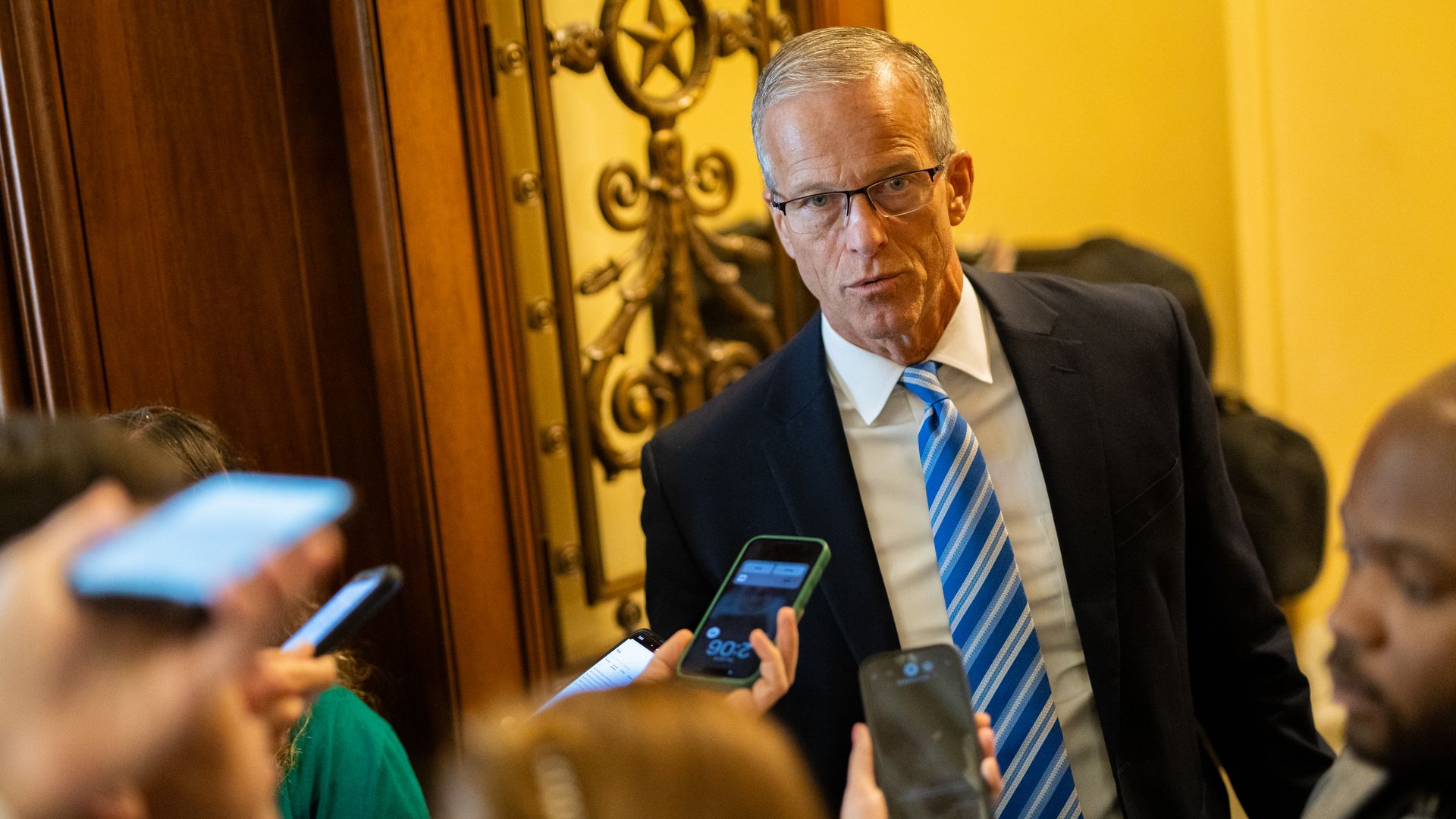 Senate Majority Leader John Thune talks with reporters at the U.S. Capitol on July 23.