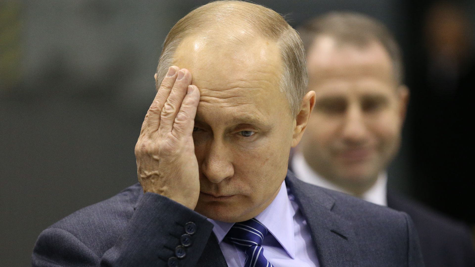 Vladimir Putin with his hand on his face