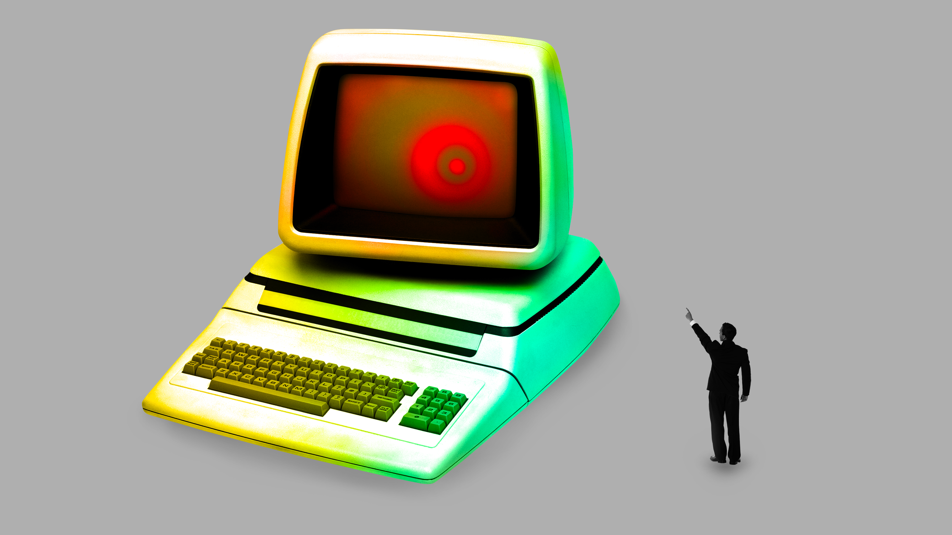 man in a suit pointing at a computer whose monitor is glowing red