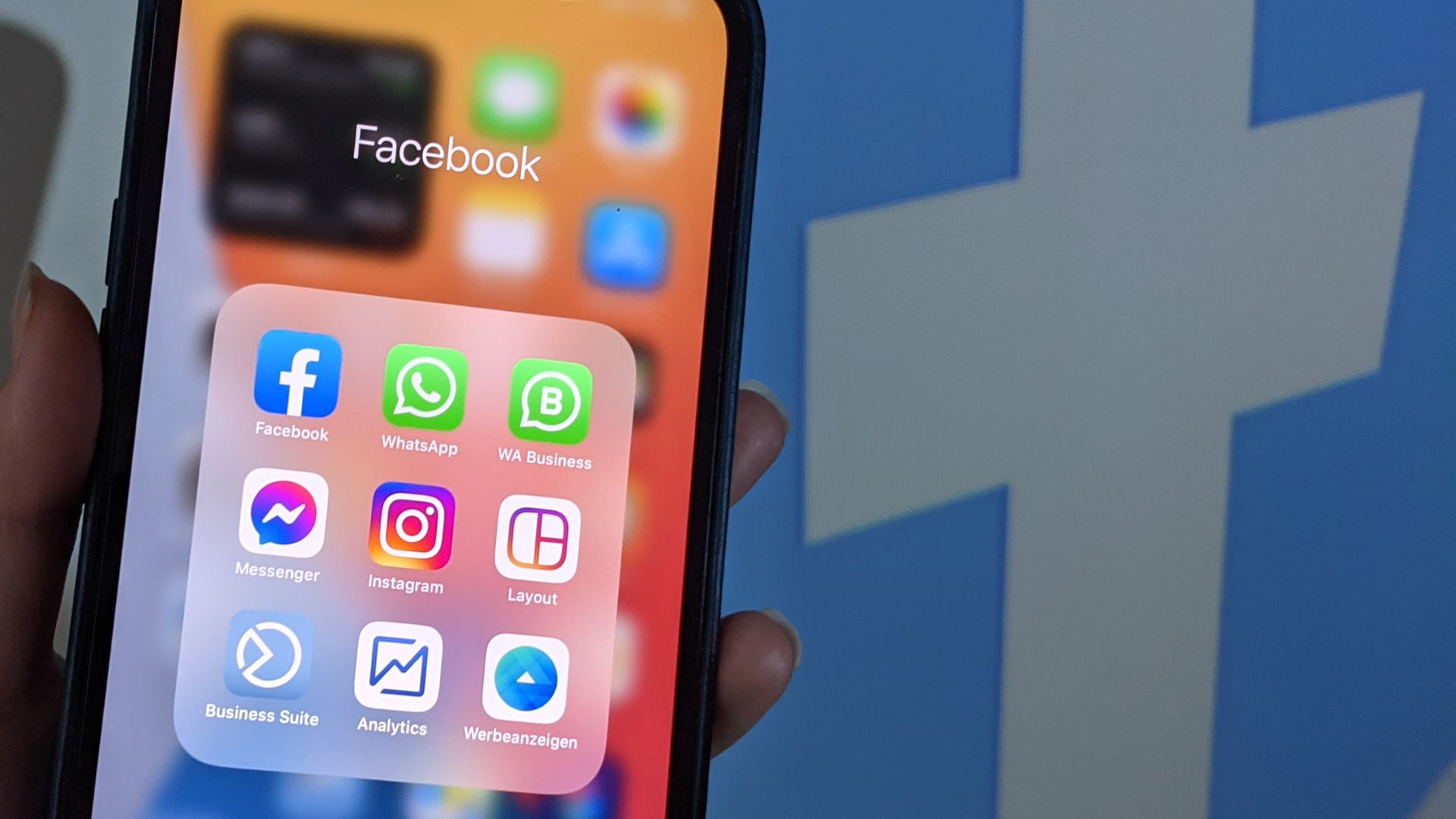 Photo of an iPhone with the Facebook suite of apps displayed on the screen