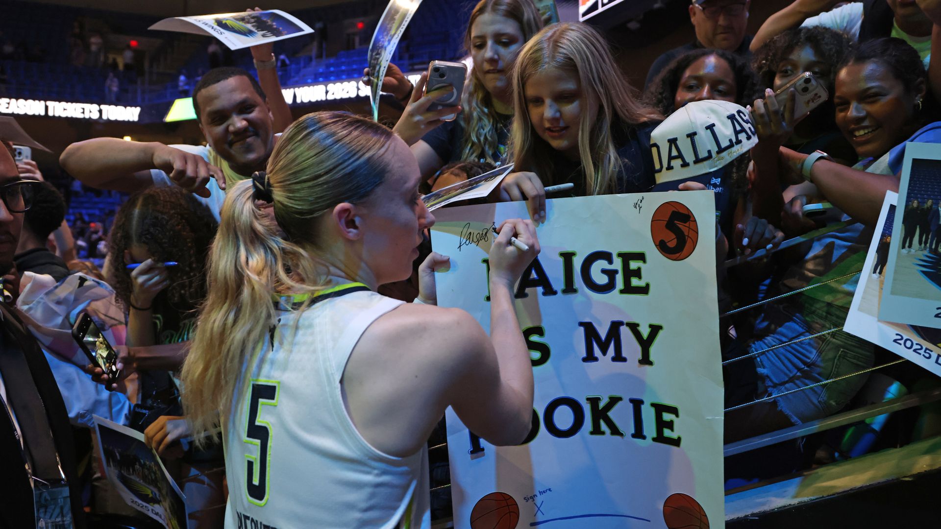 A basketball player signed a sign that says "Paige is my rookie"