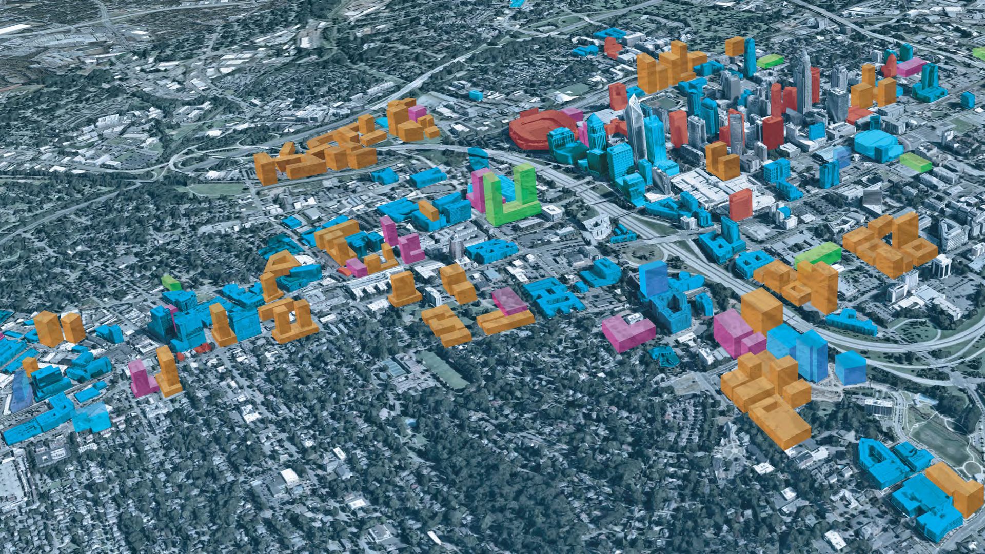 Aerial 3D map of a city with multiple buildings highlighted in blue, orange, pink, and green amid a dense urban and suburban landscape with roads and greenery.