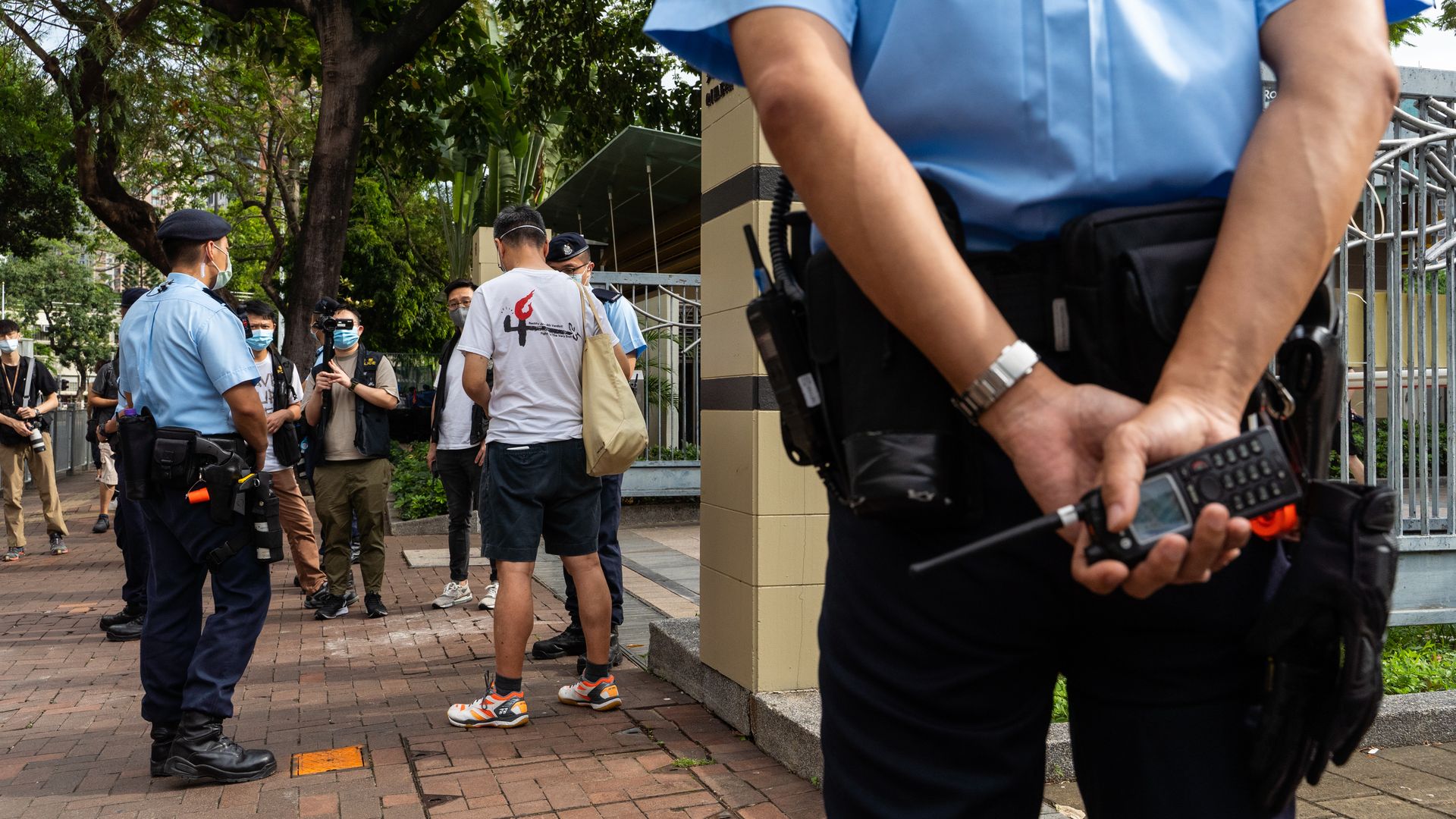 Hong Kong police searching a man on June 4 at Victoria Park, where the annual Tiananmen candlelight vigil normally takes place.
