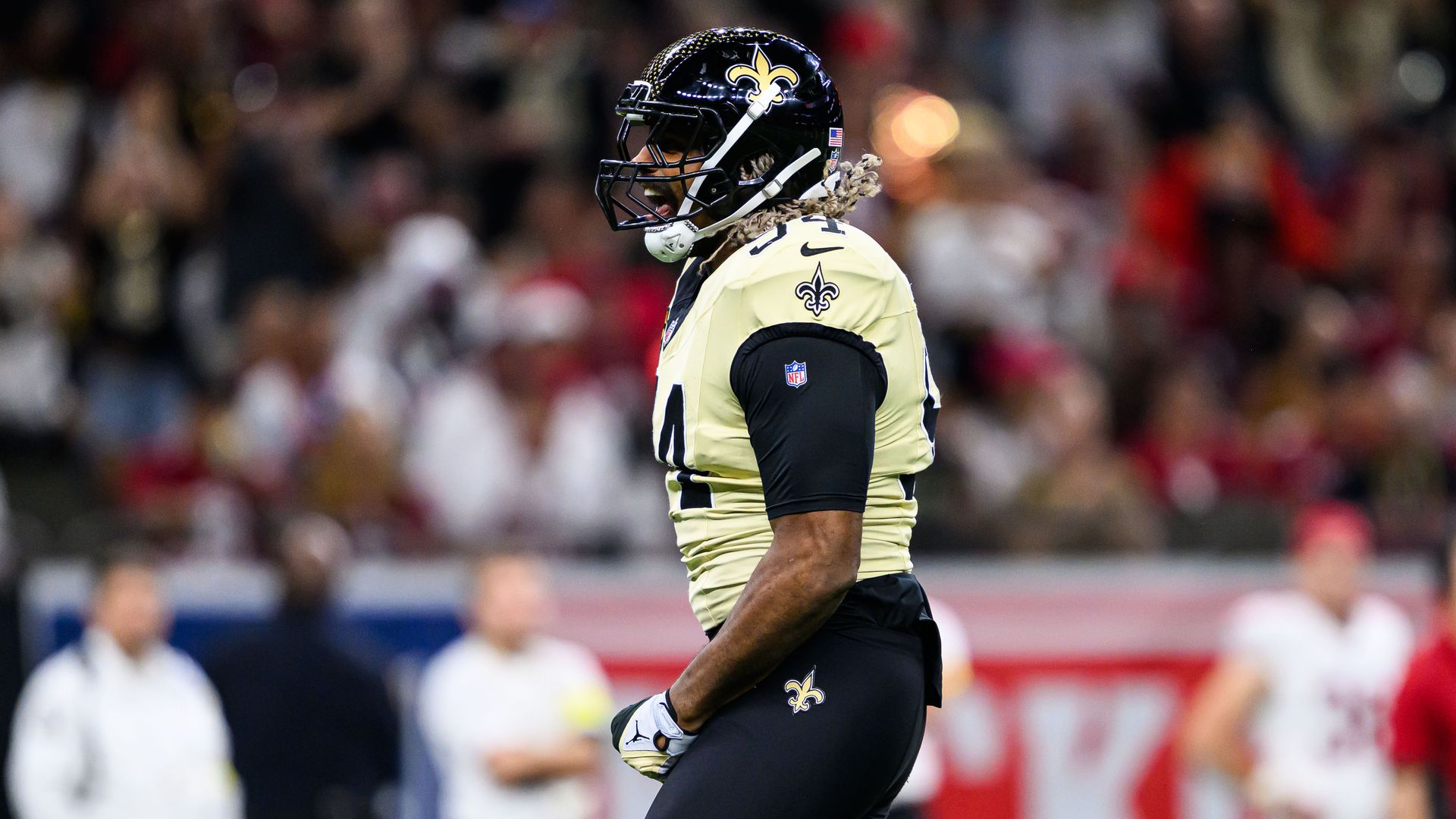 Cam Jordan, wearing a Saints uniform, reacts to a play during a game.