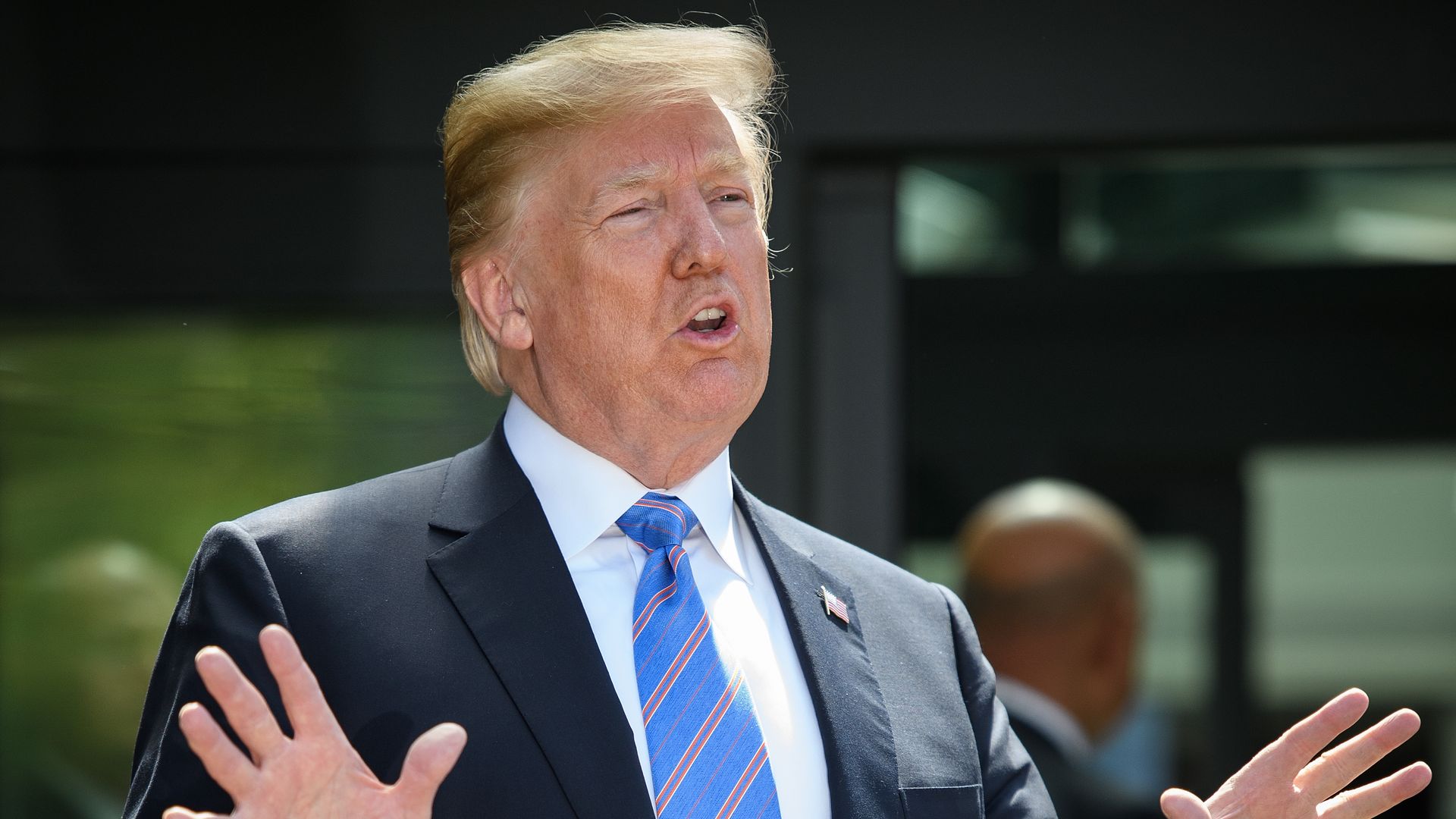 Trump speaks with his hands up