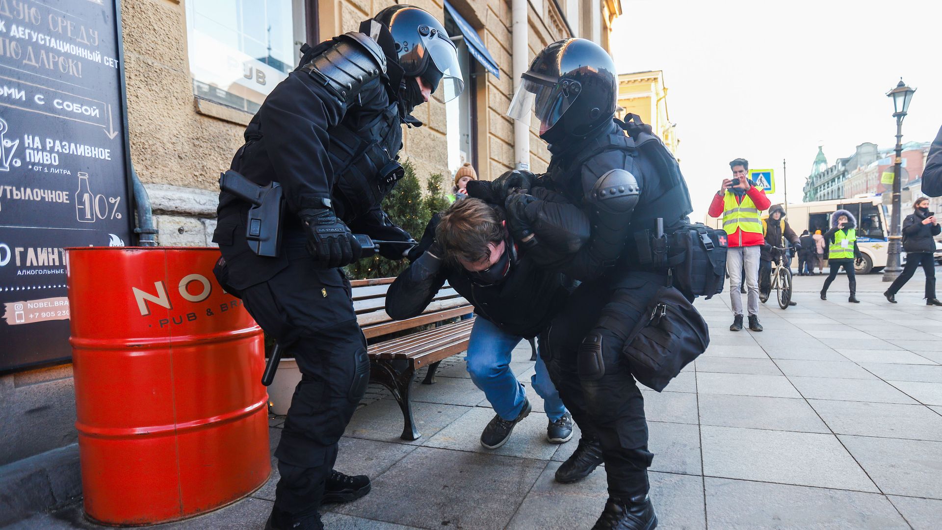 Police Officers detain a protestor during a demonstration against the Russian military operation in Ukraine.