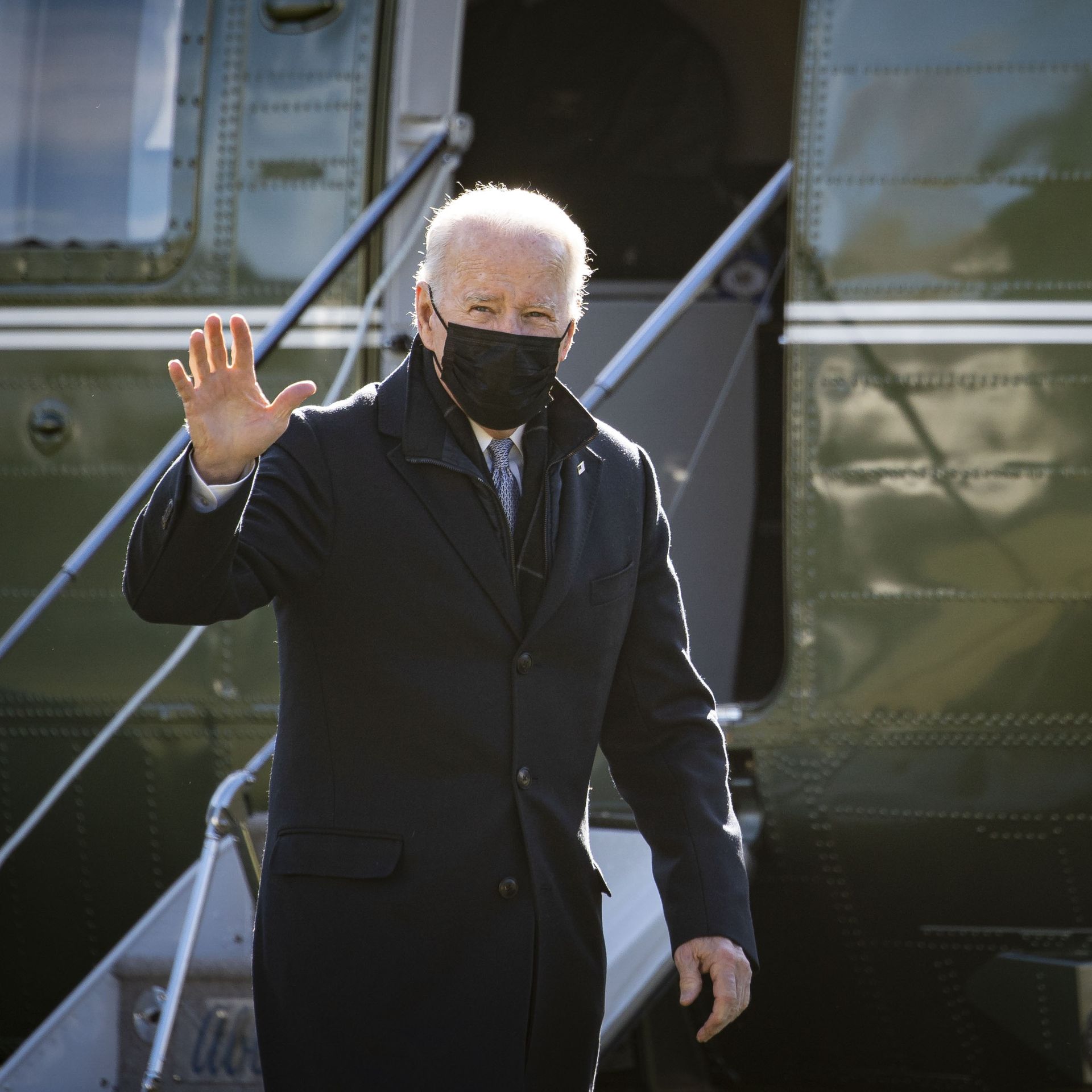 President Joe Biden waves while walking on the South Lawn of the White House after arriving on Marine One.