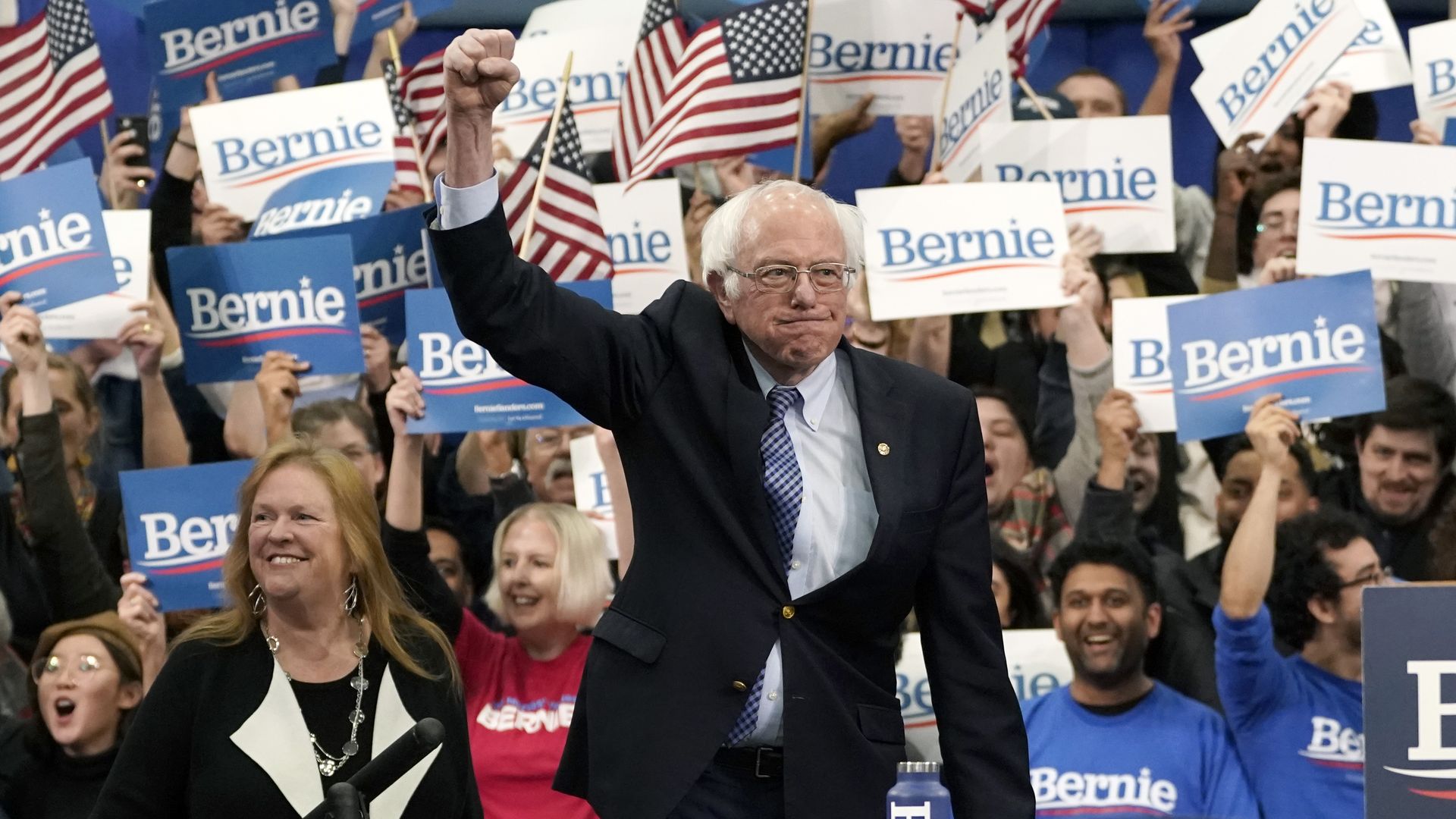 Bernie Sanders raises his fist in victory at his New Hampshire primary night party