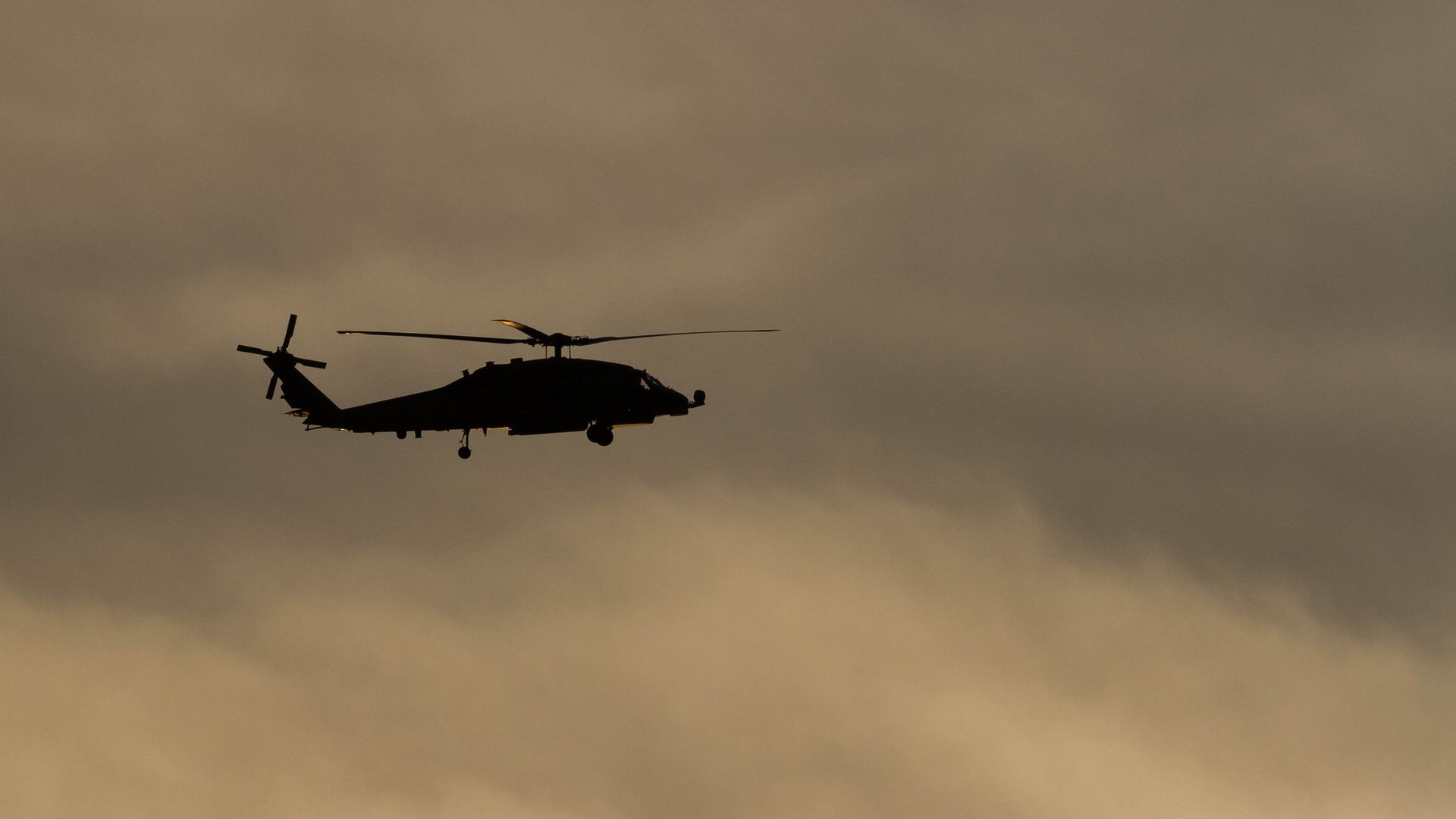 A silhouette of a US Navy Sikorsky SH-60R Seahawk helicopter with the the Maritime Strike Squadron 51 .