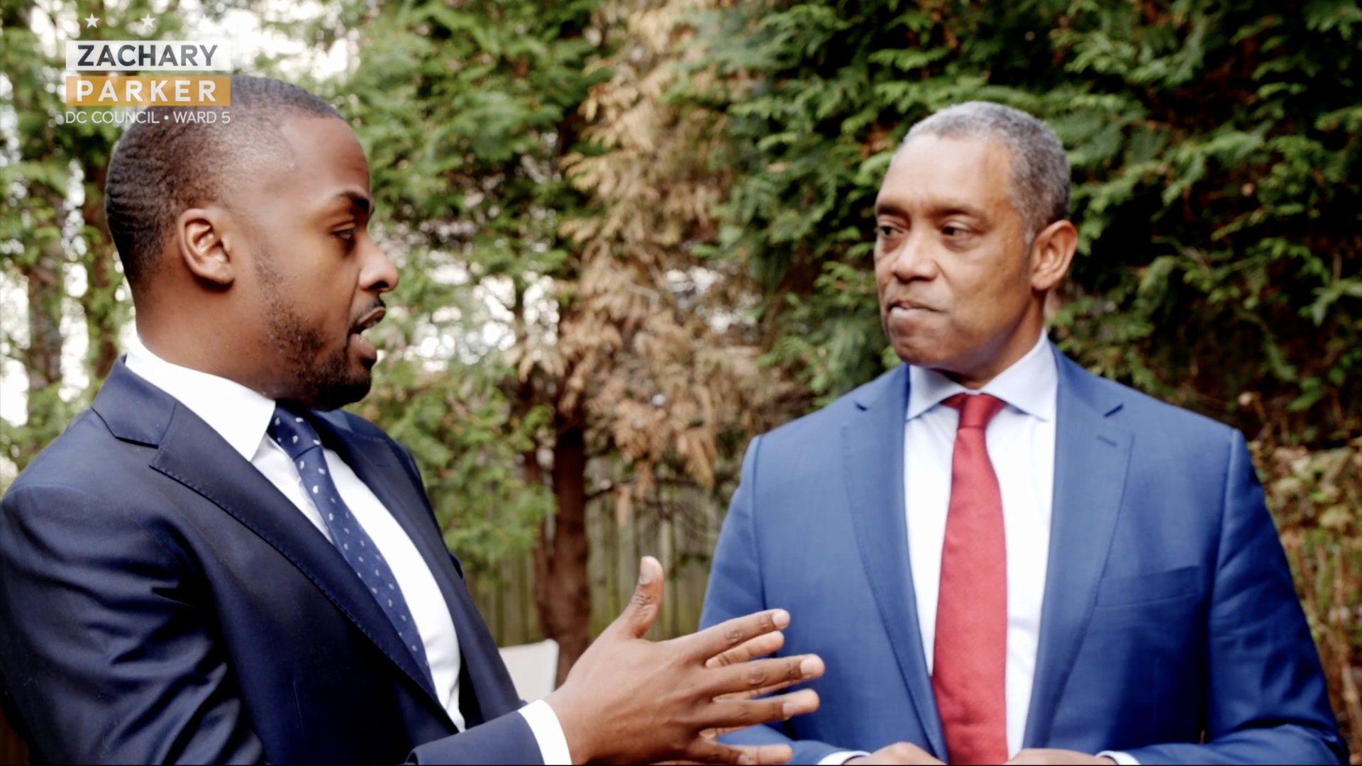 Zachary Parker and Karl Racine having a conversation, taken from a campaign video.