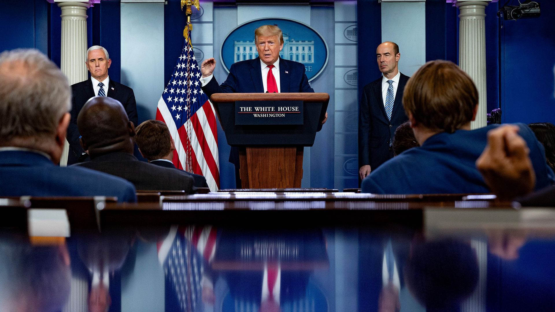 US President Donald Trump speaks, flanked by US Vice President Mike Pence (L) and US Secretary of Labor Eugene Scalia (R) during the daily briefing on the coronavirus,