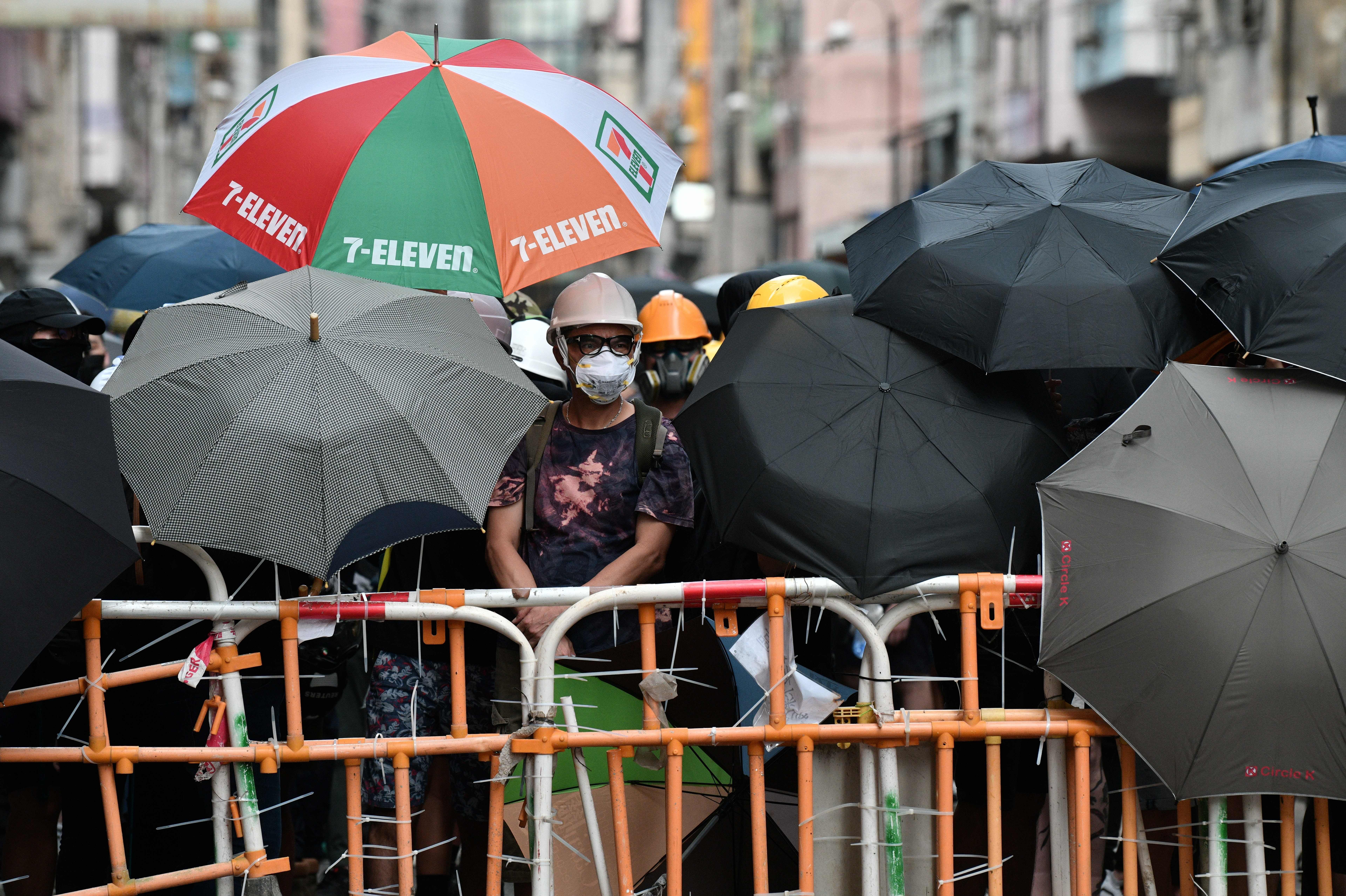 Protestors wield umbrellas