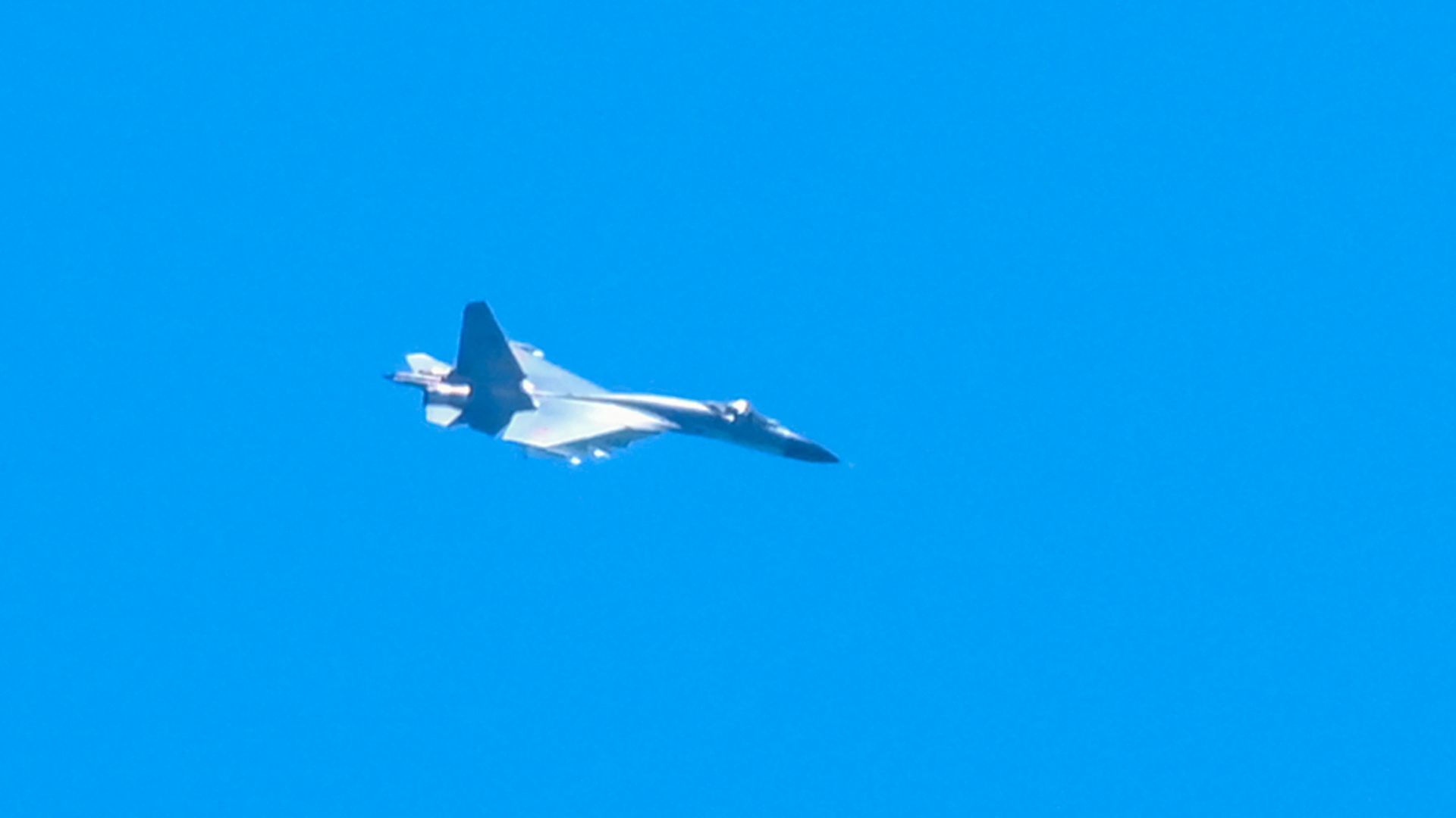 A Chinese military jet flies over Pingtan island, one of mainland China's closest point from Taiwan, in Fujian province on August 5.
