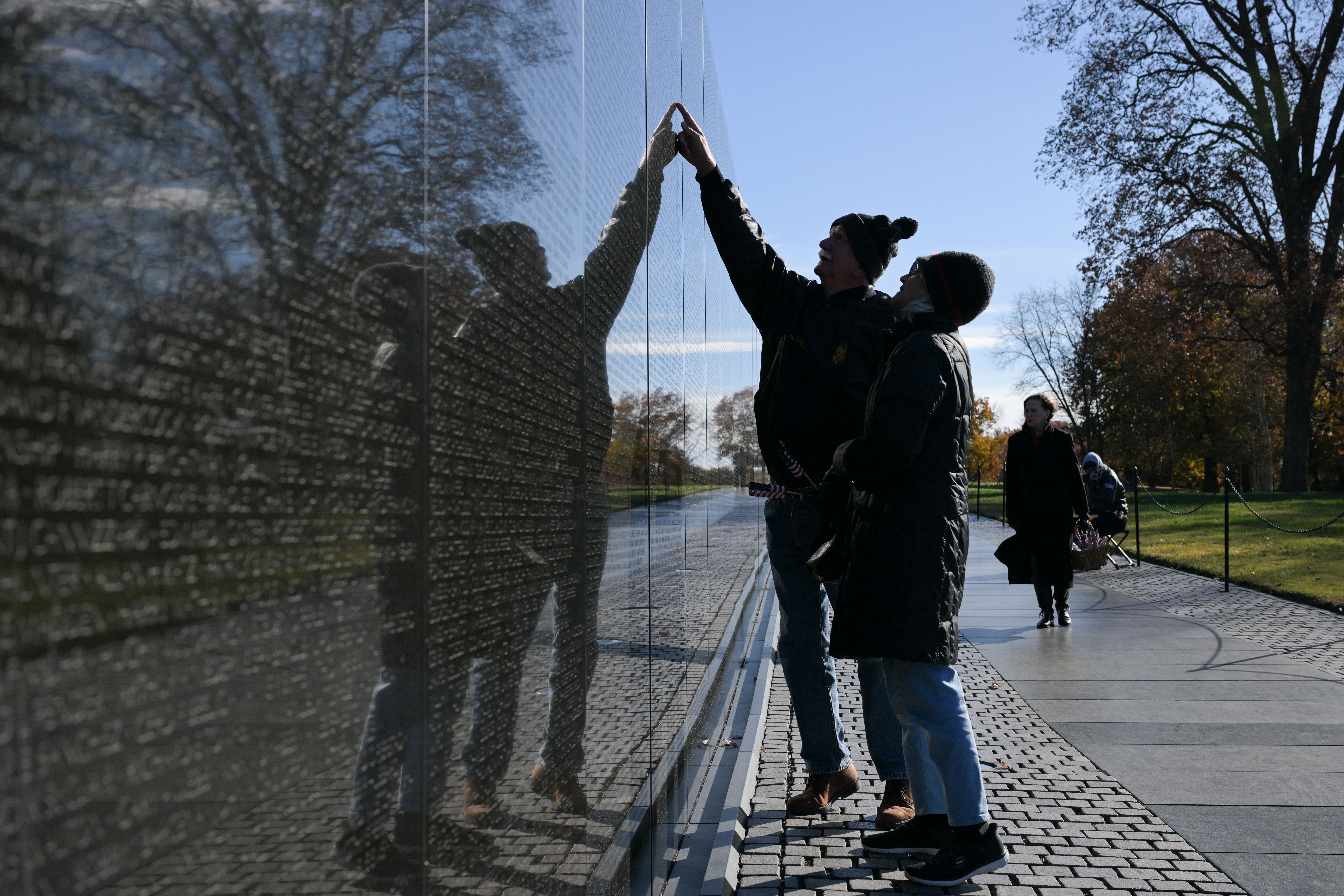 People visit the Vietnam Veterans Memorial in observance of Veterans Day in Washington, DC on November 11, 2025. (Photo by Oliver Contreras / AFP) (Photo by OLIVER CONTRERAS/AFP via Getty Images)
